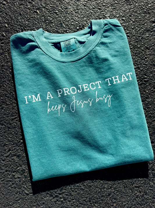 I'M A PROJECT THAT KEEPS JESUS BUSY TEE | SEAFOAM