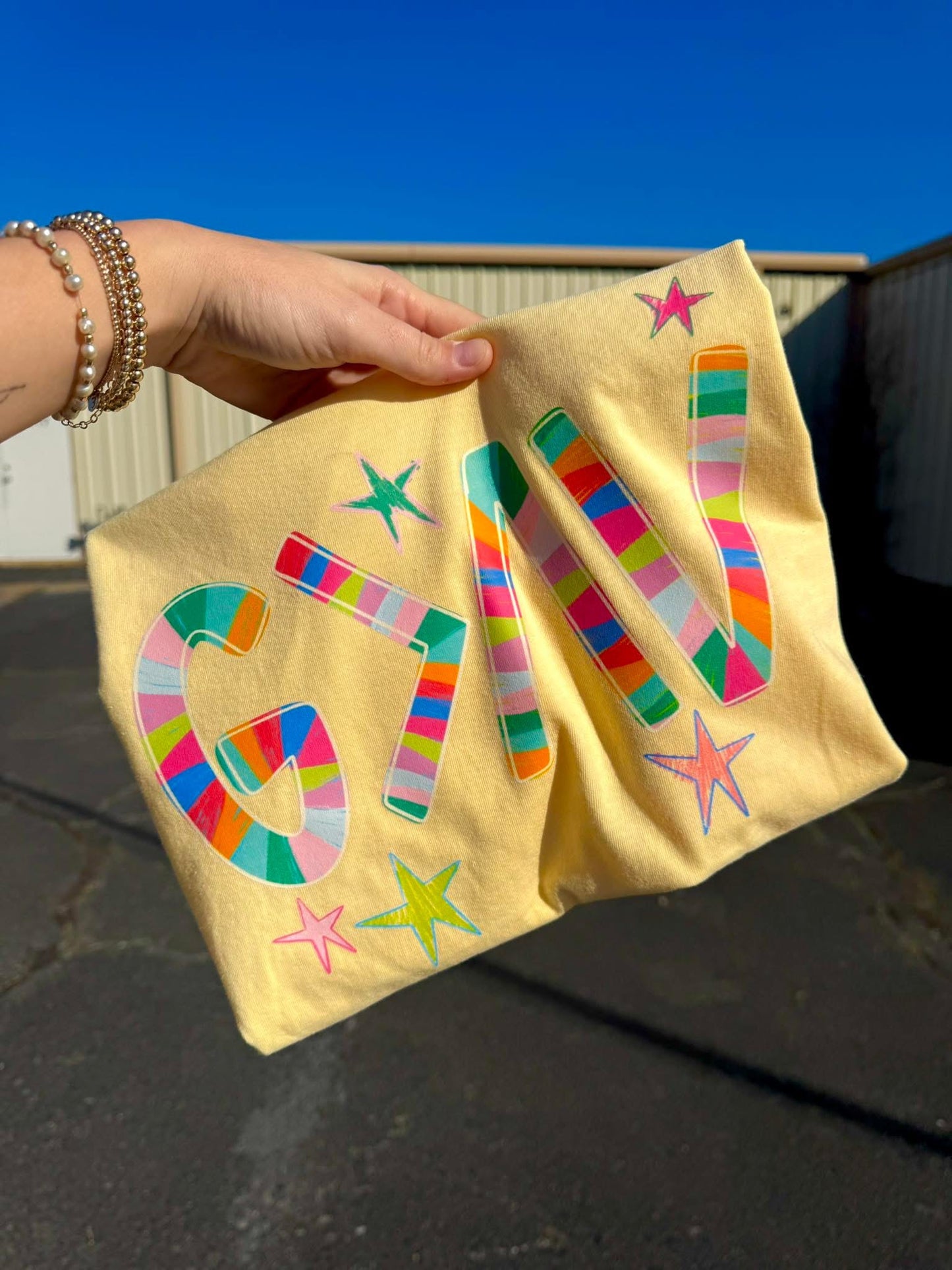 GOD IS GREATER THAN THE HIGHS AND THE LOWS GRAPHIC TEE | COLORS